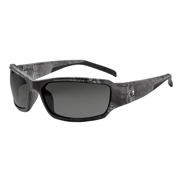 Ergodyne Skullerz THOR Safety Glasses with Kryptek Typhon Frame and Polarized Smoke Lenses. A close-up of a pair of sunglasses with a black and grey logo.