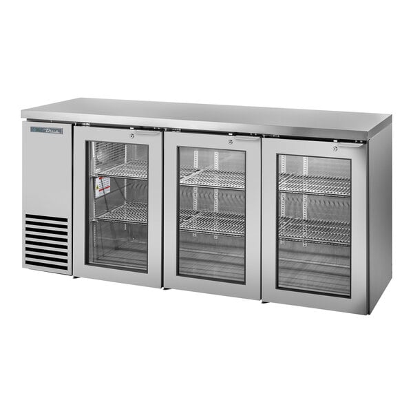 A True stainless steel back bar refrigerator with three glass doors.