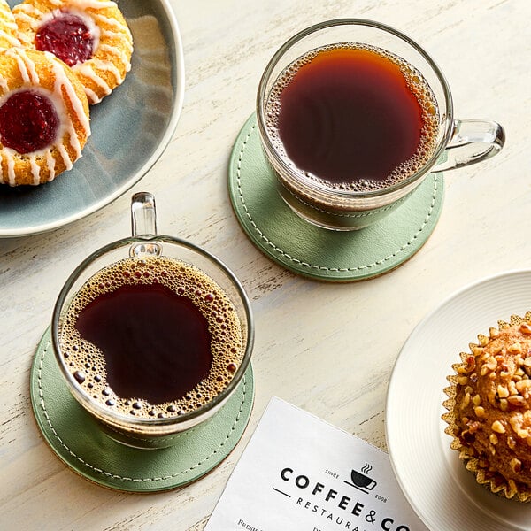 A cup of Green Mountain Coffee with pastries on a table.