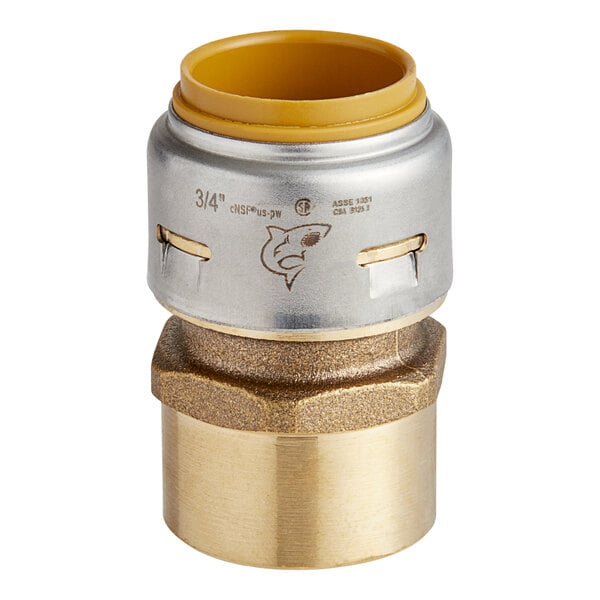 A SharkBite brass straight adapter with gold and metal fittings.