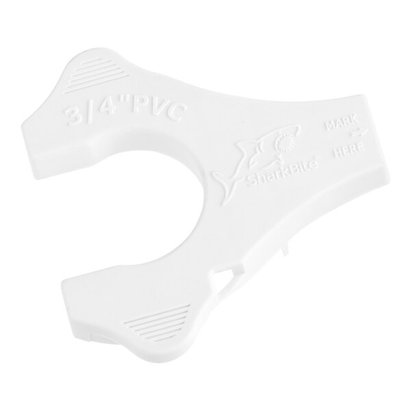 A white plastic SharkBite disconnect clip with text on it.