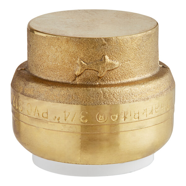 A gold cylinder with a SharkBite logo and white base.