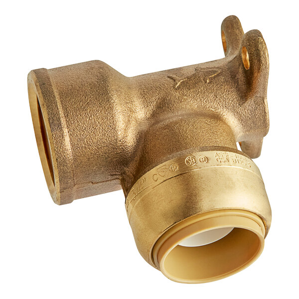 A SharkBite brass pipe fitting with a white background.
