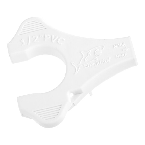 A white plastic SharkBite tool with text.