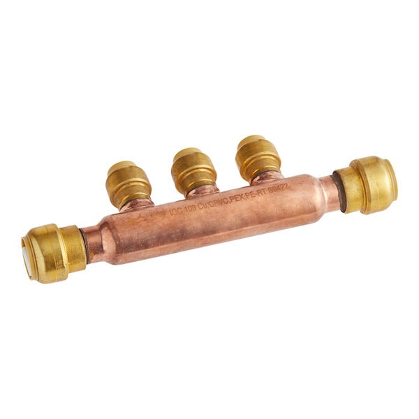 A copper pipe with a SharkBite brass tee manifold connected to three brass fittings.