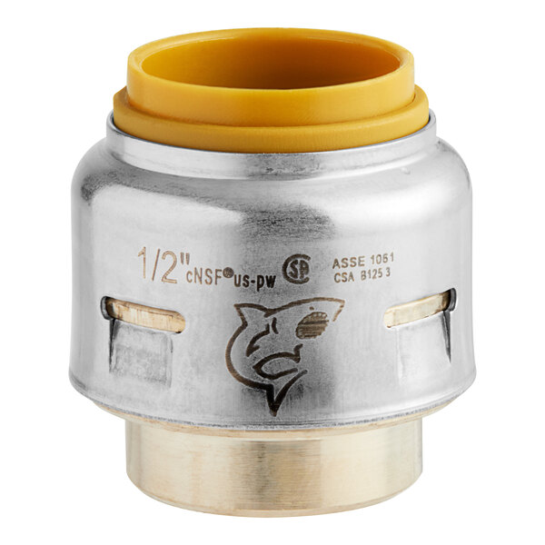 A SharkBite Max brass end cap with yellow accents.
