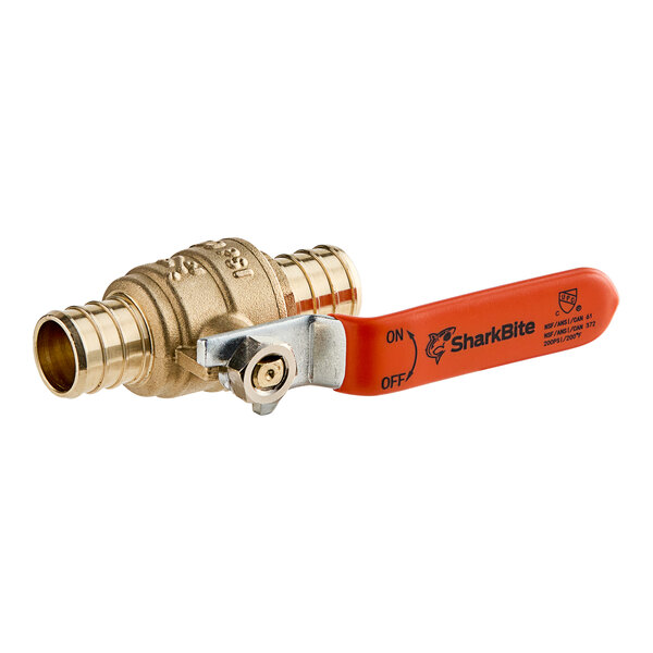 A SharkBite brass crimp ball valve with an orange handle.