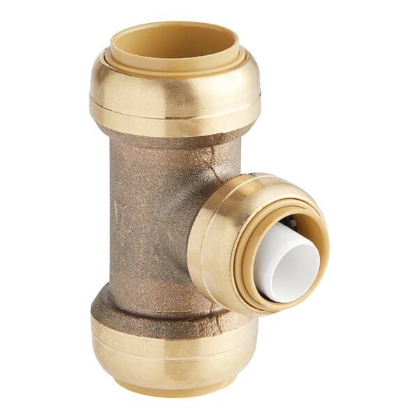 A close-up of a gold and bronze SharkBite brass pipe fitting with a white cap.