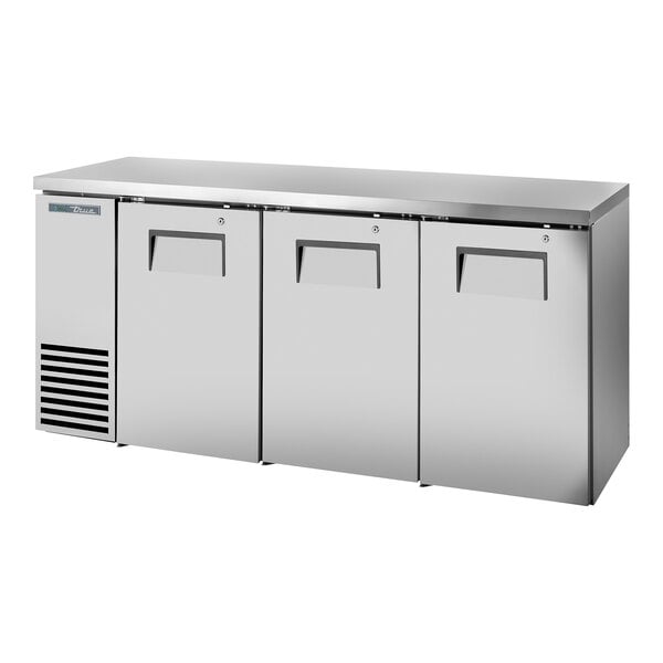 A stainless steel True back bar refrigerator with three doors open.