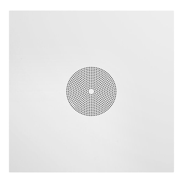 An off-white circular grille with small black dots in a circular pattern.