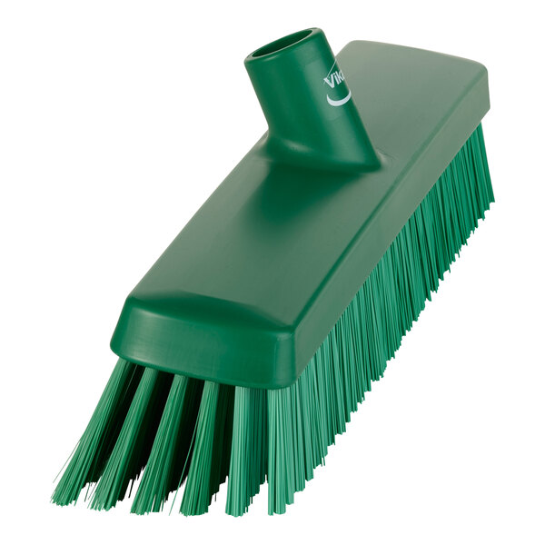 A green Vikan heavy-duty push broom head with soft/stiff bristles.