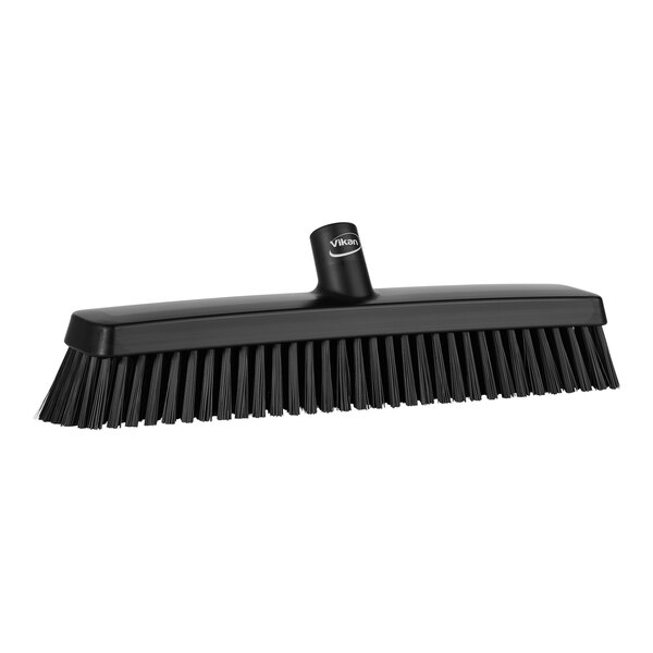 A black Vikan heavy-duty push broom head with soft and stiff bristles.