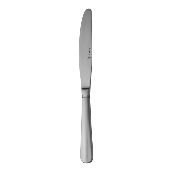 A Sola stainless steel dinner knife with a white handle.