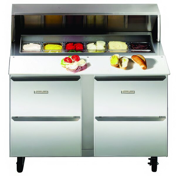 A Traulsen stainless steel sandwich prep table with food inside.