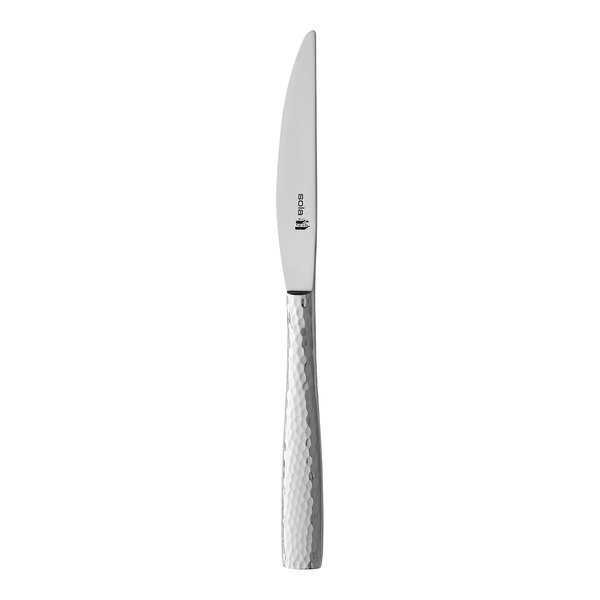 A Sola stainless steel butter knife with a textured white handle.