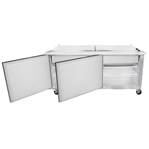 A stainless steel Traulsen refrigerator with two open doors.