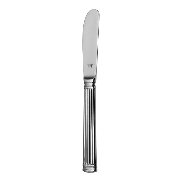A silver butter spreader with a handle.