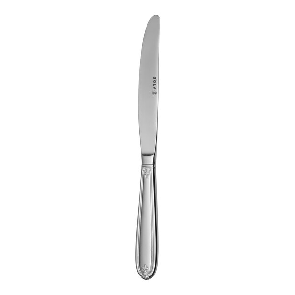 A Sola stainless steel dinner knife with a white handle.