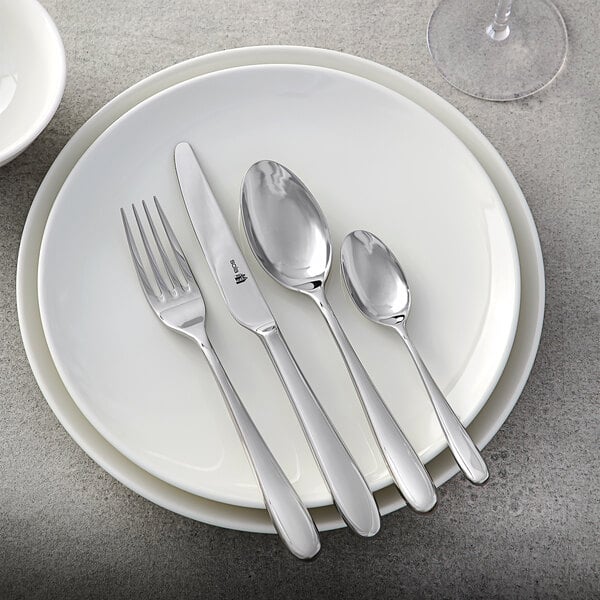 A white plate with a Sola the Netherlands stainless steel steak knife on it.