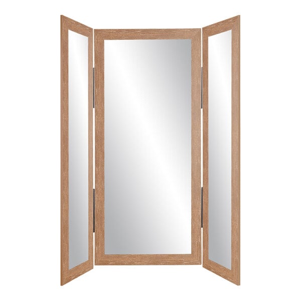 A BrandtWorks trifold dressing mirror with a wooden frame.