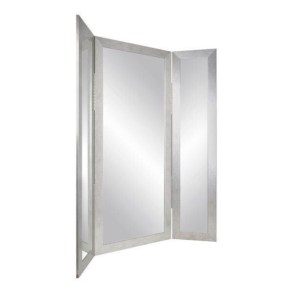 A white rectangular object with a silver framed trifold mirror on it.