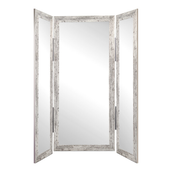 A white rectangular BrandtWorks trifold dressing mirror.