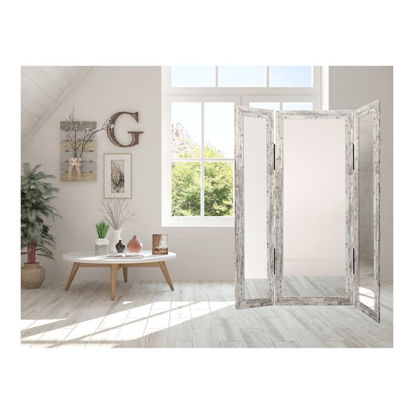 A white room with a BrandtWorks white trifold dressing mirror.