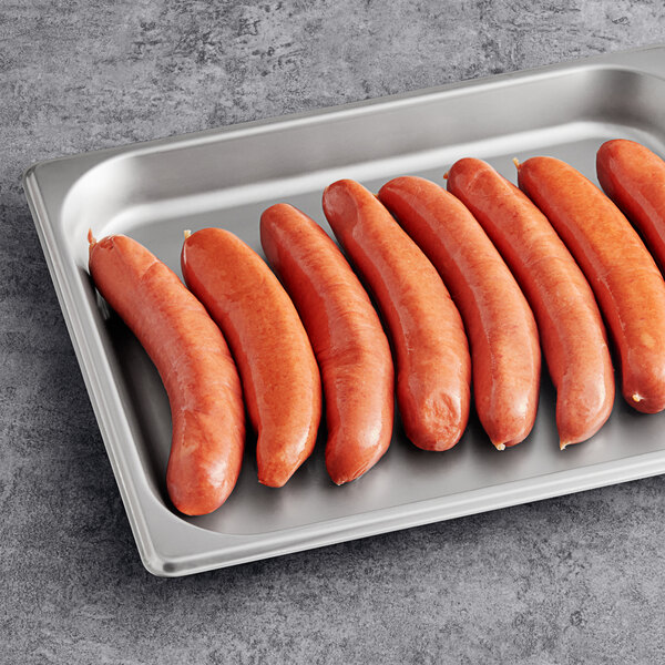 A tray of Sabrett knockwurst sausages on a gray surface.