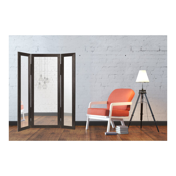 A room with a BrandtWorks trifold dressing mirror and a chair.