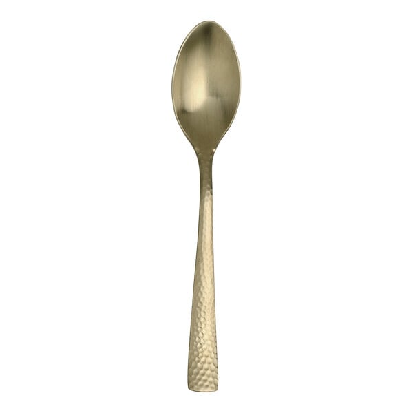 A close up of a Varick Malcolm stainless steel teaspoon with a gold handle.