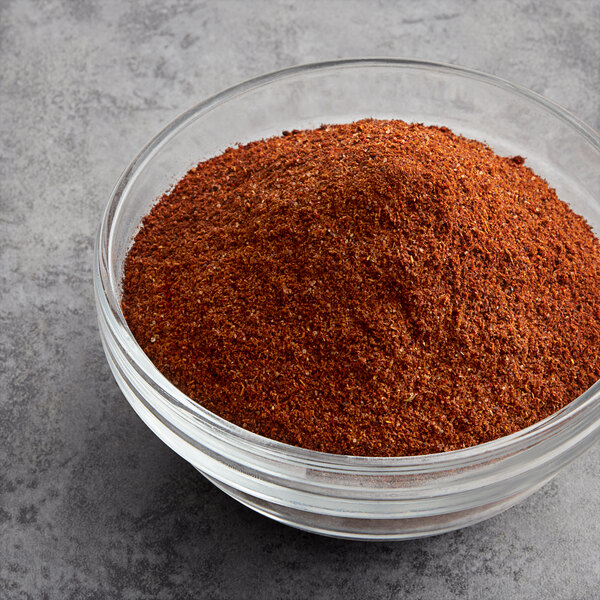 A bowl of McCormick Culinary Choice Chili Powder on a gray surface.