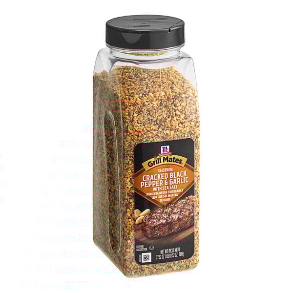 A jar of McCormick Grill Mates Cracked Black Pepper and Garlic with Sea Salt Seasoning on a table with a label.