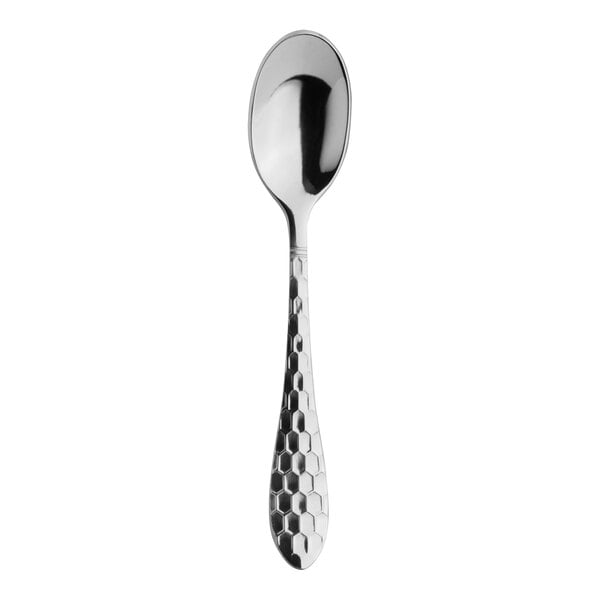 A close-up of a Varick stainless steel coffee spoon with a honeycomb design.