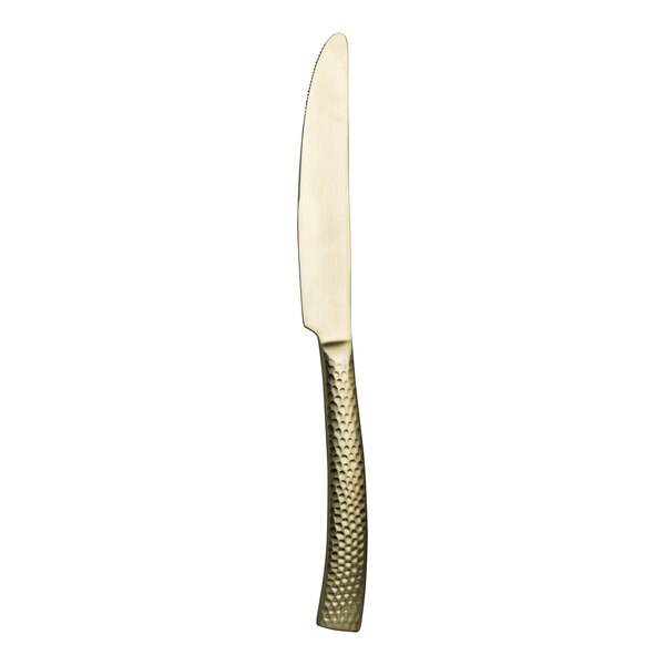 A close up of a Varick Malcolm Champagne Gold stainless steel dinner knife with a wooden handle.