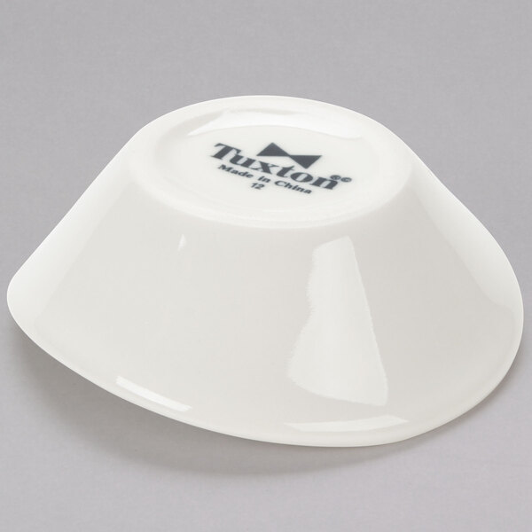 A Tuxton eggshell china bowl with black text on it.