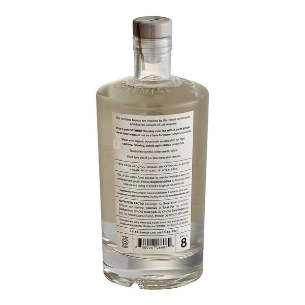 A bottle of Optimist Botanicals Smokey Non-Alcoholic Spirit with a label on it.