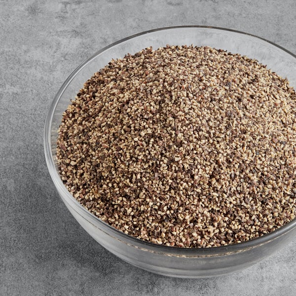 A glass bowl of McCormick Culinary Coarse Ground Black Pepper.