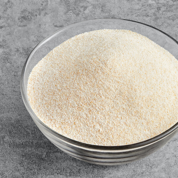 A bowl of McCormick Culinary Garlic Salt on a white surface.