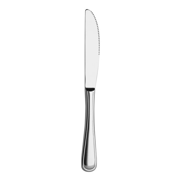 A silver Varick Charleston dinner knife with a white handle.