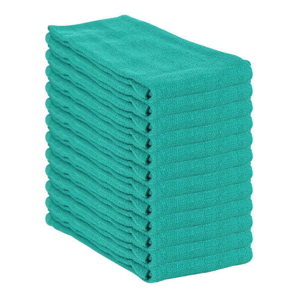 A stack of hunter green Monarch Brands huck towels.