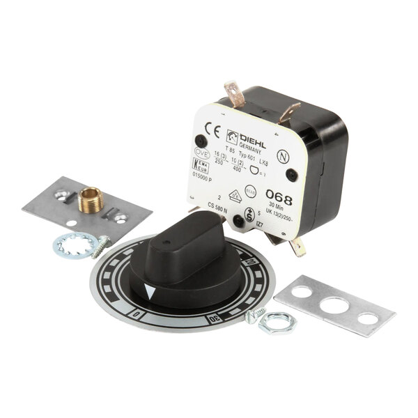 A metal plate with a round black and white timer switch and screws.