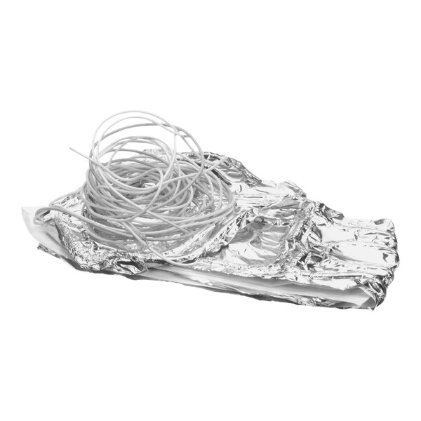 A silver foil package with a white wire inside.