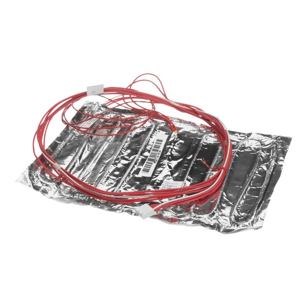 A close-up of a silver foil heater with red wires.