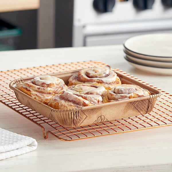 A Solut oven-safe kraft board tray with cinnamon rolls on it.