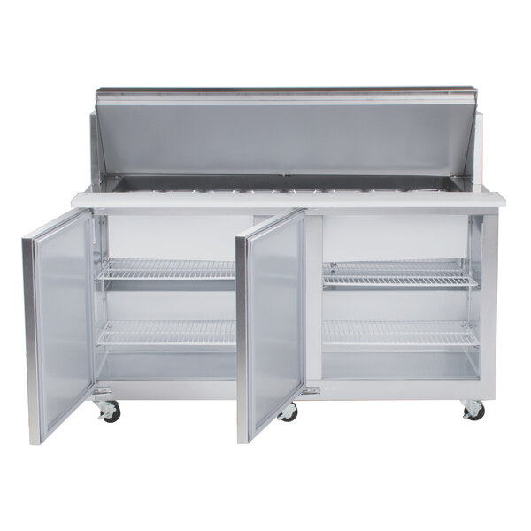 A stainless steel refrigerated counter with two doors and shelves.