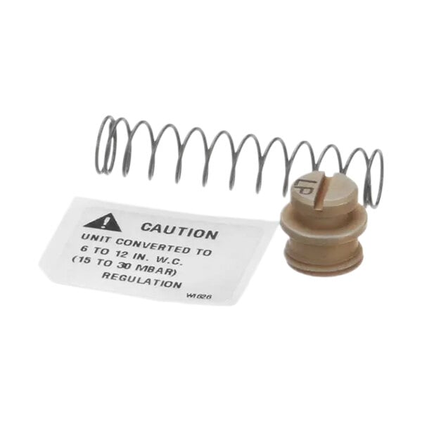 A metal spring and white caution label.