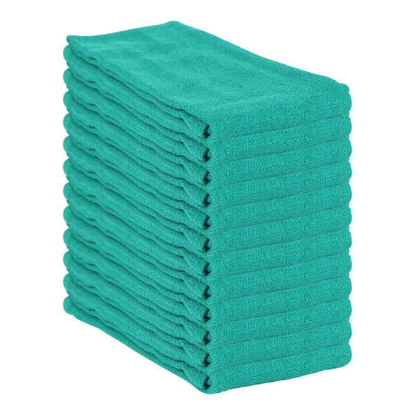 A stack of hunter green Monarch Brands huck towels.