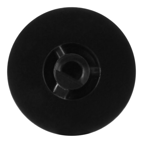 A close up of a black plastic thermostat knob with a hole in the center.