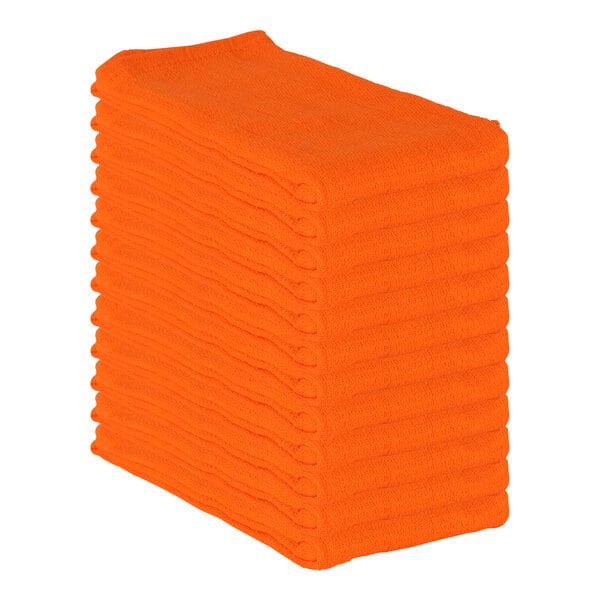 A stack of orange Monarch Brands huck towels.