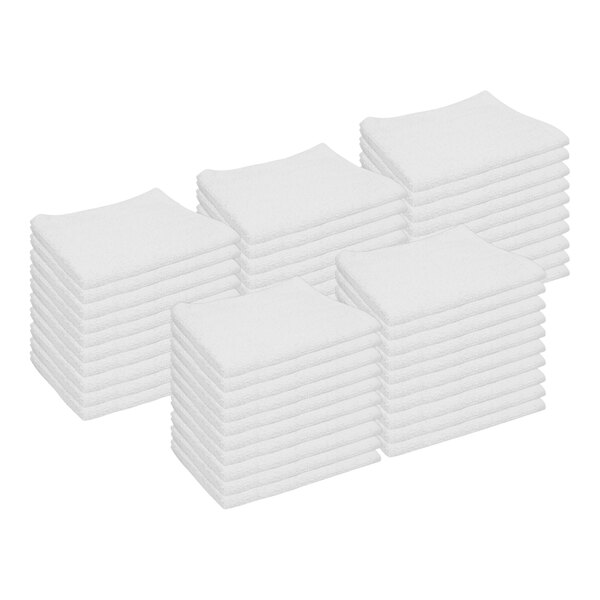 A stack of white Monarch Brands utility terry towels.